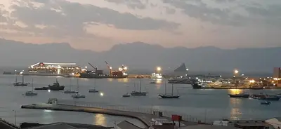 a harbor with boats in the water at night at Apartamento Augusta Amwilla Guesthouse in Mindelo
