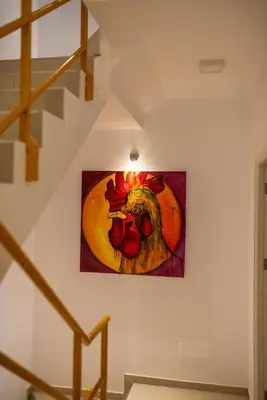 a painting of a chicken on a wall at Apartamento Augusta Amwilla Guesthouse in Mindelo