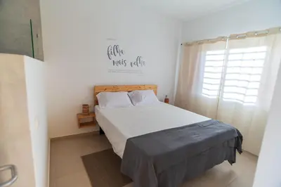 a bedroom with a bed and a window at Amwilla Guesthouse Quarto WC privativo Elsa in Mindelo