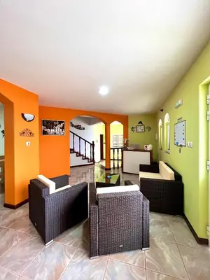 a living room with orange and green walls at Casa BB&Djassi - SUITES in Ponta do Sol