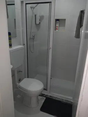 a bathroom with a toilet and a shower at Ana Place in Praia