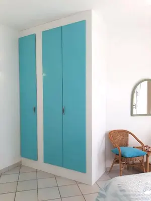 a glass door in a bedroom with a chair at Beach house Agua Viva, Praia de Chaves, Boa Vista, Sal Rei, Cape Vert, 50mt spiaggia in Cabeçadas