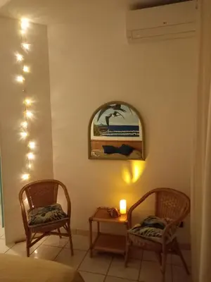 a room with two chairs and a table and a mirror at Beach house Agua Viva, Praia de Chaves, Boa Vista, Sal Rei, Cape Vert, 50mt spiaggia in Cabeçadas