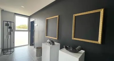 a room with two pictures on the wall and a black wall at DESIGN SUITES Boutique Hotel - Adults Only in Santa Maria