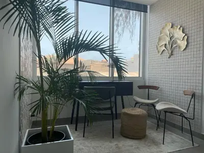 a dining room with a table and a plant at DESIGN SUITES Boutique Hotel - Adults Only in Santa Maria
