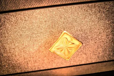 a gold object sitting on top of a table at DESIGN SUITES Boutique Hotel - Adults Only in Santa Maria