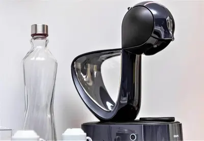 a blow dryer sitting next to a glass bottle at DESIGN SUITES Boutique Hotel - Adults Only in Santa Maria