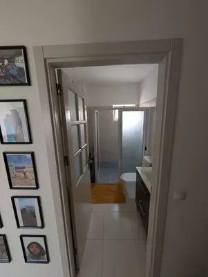 a white bathroom with a toilet and a sink at Casa Relaxod in Santa Maria