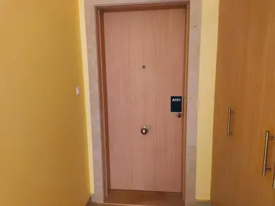 a wooden door with a sign on it in a hallway at Apartamento Privado Vila Verde in Santa Maria