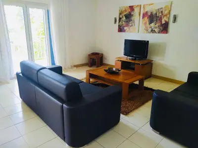 a living room with a couch and a tv at Apartamento Privado Vila Verde in Santa Maria