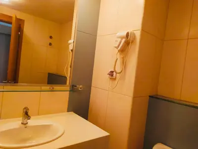 a bathroom with a sink and a phone on the wall at Apartamento Privado Vila Verde in Santa Maria