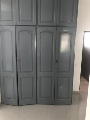 a set of four doors in a room at Apartamento T1 Moderno com Wi-Fi in Praia