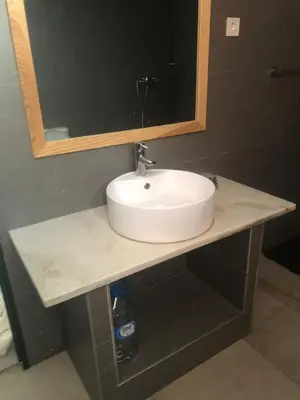 a bathroom counter with a sink and a mirror at Apartamento T1 Moderno com Wi-Fi in Praia