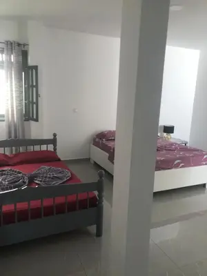 a room with two beds in a room at Apartamento T1 Moderno com Wi-Fi in Praia