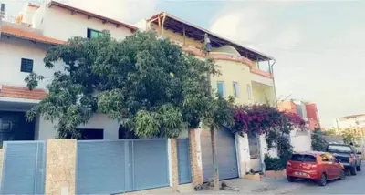 a red car parked in front of a house at Apartamento T1 Mobilado com Wi-Fi in Praia