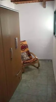 a room with a rocking chair in a room at Apartamento T1 Mobilado com Wi-Fi in Praia