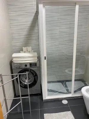 a washer and dryer in a bathroom with a window at AP2B Praia in Praia