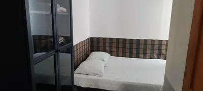 a small bed in a room with a mirror at casa verde lucas in Mindelo