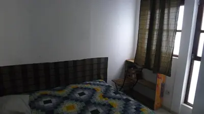 a bedroom with a bed and a window at casa verde lucas in Mindelo