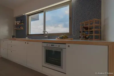 a kitchen with a sink and a counter with a window at Seafront Holiday House on the Mindelo Bay in Mindelo