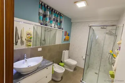 a bathroom with a sink and a shower and a toilet at Seafront Holiday House on the Mindelo Bay in Mindelo