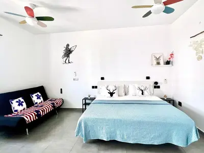 a bedroom with a bed and a couch at ANIMOSS! APARTMENTS - 10 modern apartments near city center & beach in Santa Maria