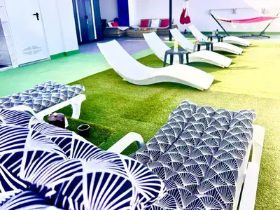 a row of white chairs and tables in a room at ANIMOSS! APARTMENTS - 10 modern apartments near city center & beach in Santa Maria
