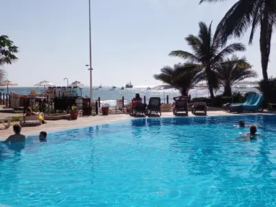 a group of people in a swimming pool near the water at Porto Antigo 2 Apt 72 TOP FLOOR WITH SEA VIEW in Santa Maria