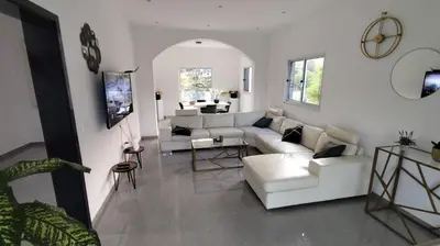 a living room with a white couch and a table at VILLA NAYELI Luxury and Simplicity in Órgãos