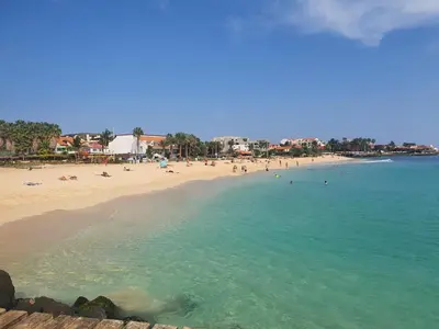 a beach with a bunch of people in the water at Appartement Amalia Sal Santa Maria in Prainha