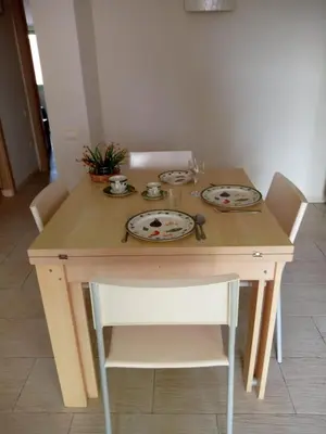 a wooden table with plates on top of it at Appartement Amalia Sal Santa Maria in Prainha