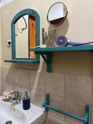 a bathroom with a sink and a mirror on a shelf at Casa Carlotta - Authentic Stay in Maio in Vila do Maio