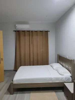 a bedroom with a bed and a window with a heater at ENZO APARTAMENTO T0 - Inforsal in Espargos