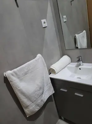 a white bathroom with a sink and a mirror at ENZO APARTAMENTO T0 - Inforsal in Espargos