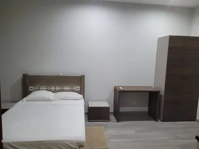 a bedroom with a bed and a nightstand and a table at ENZO APARTAMENTO T0 - Inforsal in Espargos