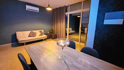 a living room with a table with a wine glass on it at Appartement Cara do Mar in Praia