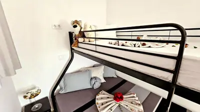 a room with two bunk beds in a room at Appartement Cara do Mar in Praia