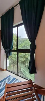 a bedroom with a large window with a view at Kasa d'Vizin in Paul