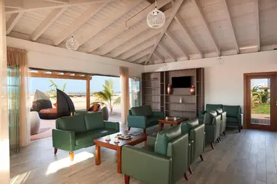 a living room with green chairs and a table at Melia Llana Beach Resort & Spa - Adults Only - All Inclusive in Santa Maria