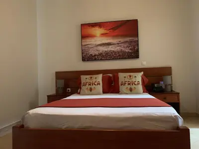 a bedroom with a bed with a picture on the wall at Damfjord Boutique Hotel in Santa Maria