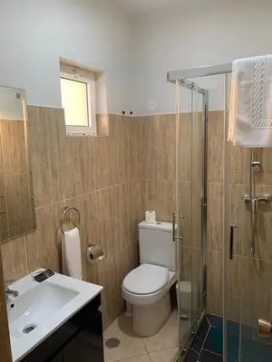 a bathroom with a toilet and a sink and a shower at Damfjord Boutique Hotel in Santa Maria