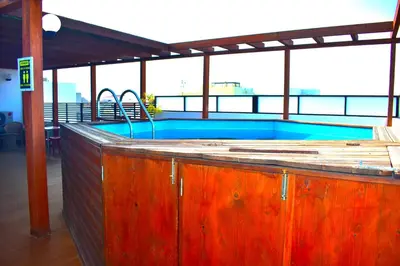 a swimming pool on top of a building at Damfjord Boutique Hotel in Santa Maria