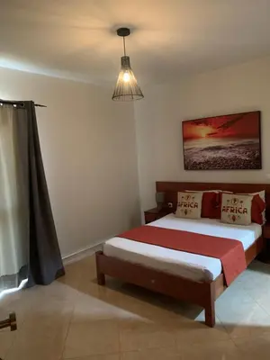 a bedroom with a bed and a pendant light at Damfjord Boutique Hotel in Santa Maria