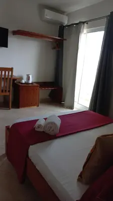 a bedroom with a bed with towels on it at Damfjord Boutique Hotel in Santa Maria