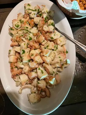 a white plate of food with shrimp and mushrooms at Vilas na areia aparthotel in Sal Rei