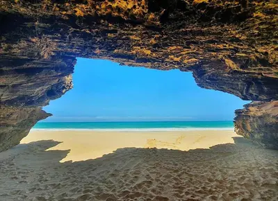 a view of the beach from inside a cave at Vilas na areia aparthotel in Sal Rei