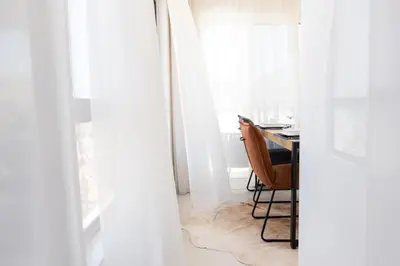 a room with a table and a chair next to a window at Penthouse with jacuzzi and sea view, Morabeza Deluxe in Mindelo