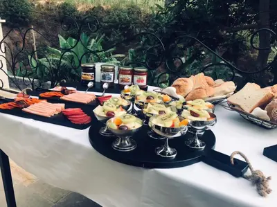 a table with several bowls of food on it at Hotel Château Georgette in Pombas