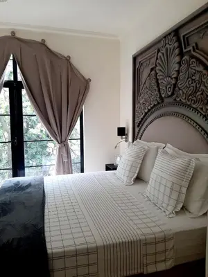 a bedroom with a large bed and a window at Hotel Château Georgette in Pombas