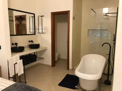 a bathroom with a tub and a sink and a shower at Hotel Château Georgette in Pombas